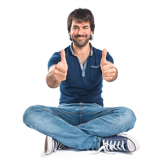 Man with thumbs up sitting on the floor